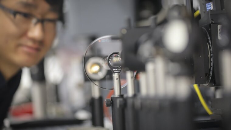 PhD student analyzes nanostructures on a wafer.